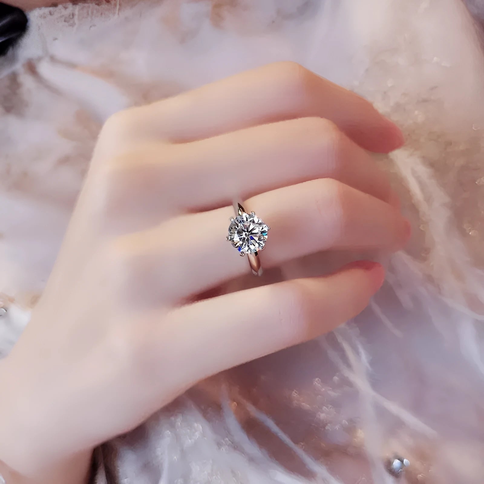 White gold plated ring with six-claw setting holding a central zircon stone on a geometric band.
