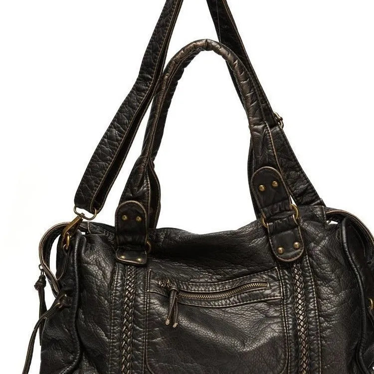 Women's retro motorcycle shoulder bag in bright black with golden edge or brown, showing internal compartments and slit pockets