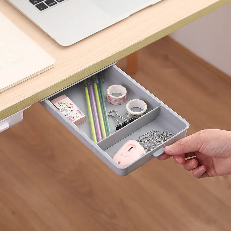 Small white plastic storage box with a lid and grid interior, mounted under a wooden table.