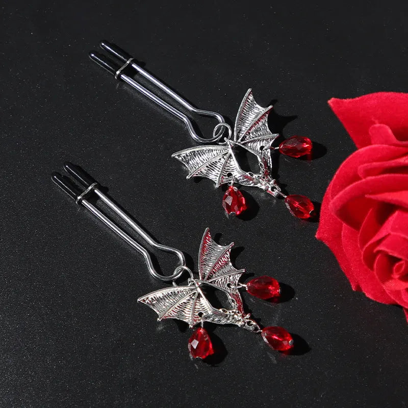 Silver alloy bat nipple clamp with red ruby bat clip decoration.