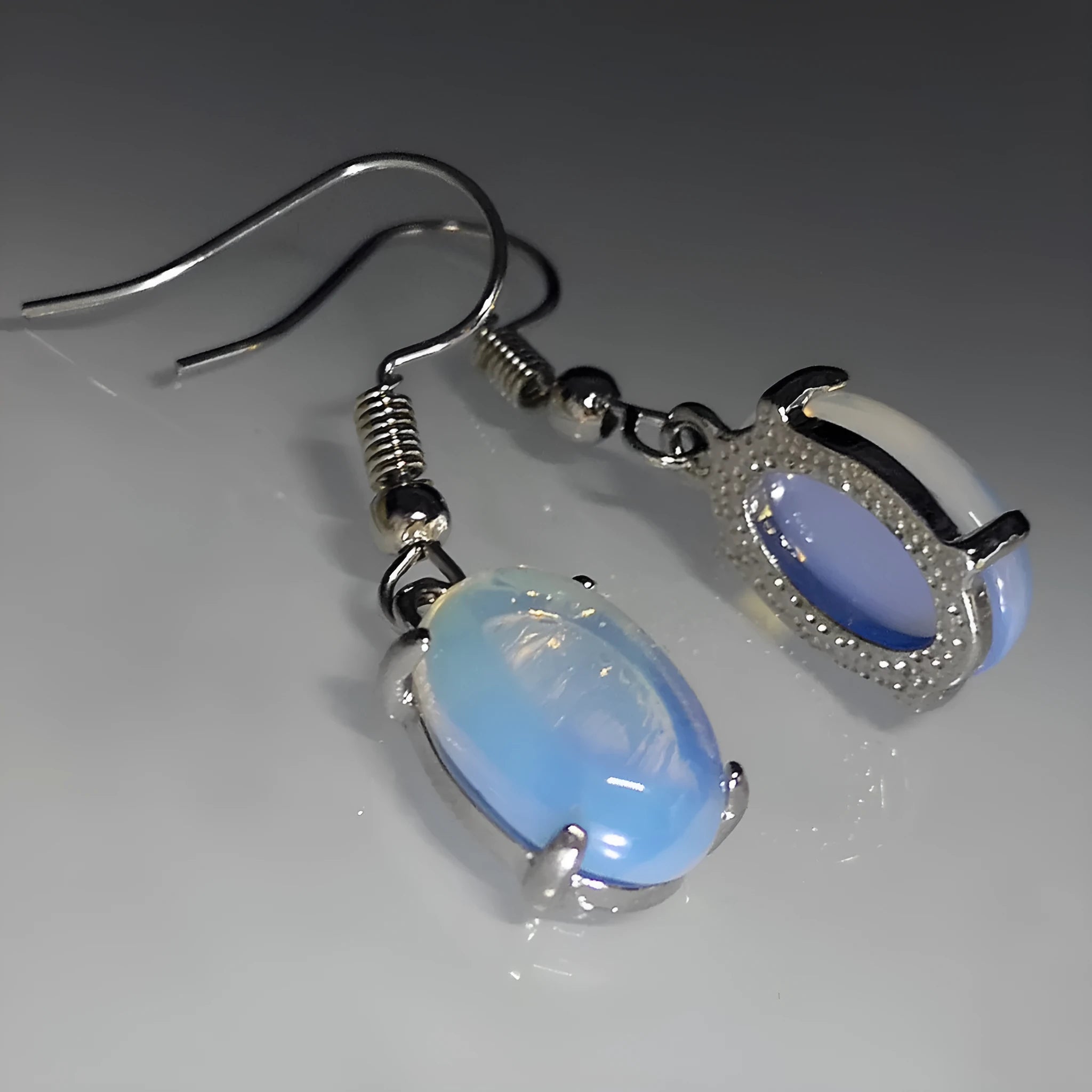 Moonlight White opal-coloured drop earrings with an ellipse design on a retro-inspired alloy setting.
