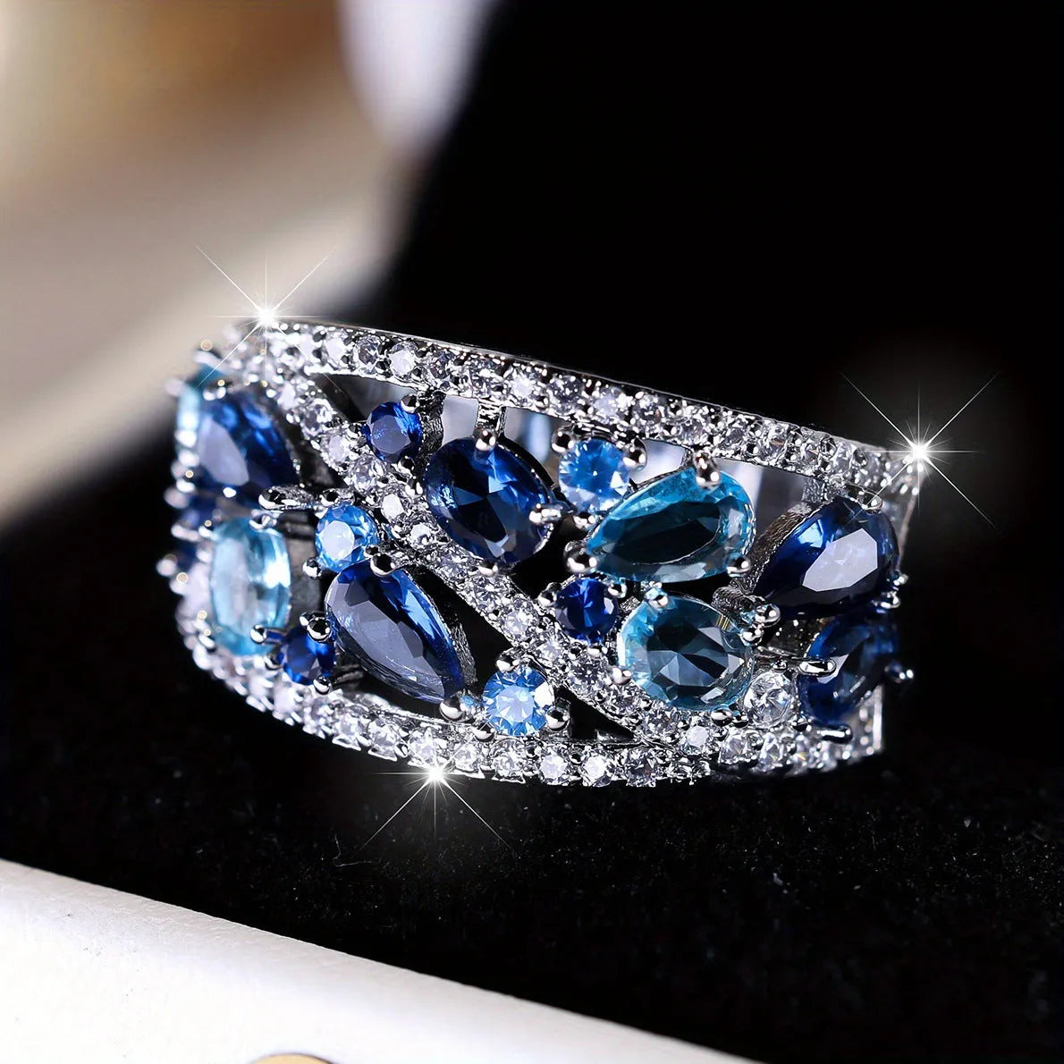 Women's hollow round copper fashion ring showing gold and platinum finish options with white and blue stone effects