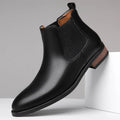 Men's black Chelsea high-top boots with a pointed toe and low rubber sole on a white background.
