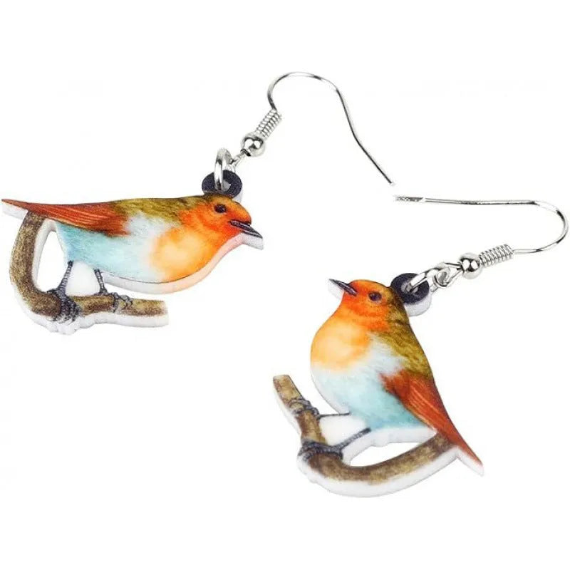 A pair of blue titmouse bird pendant earrings made from clear acrylic with geometric shapes and snake chain links.