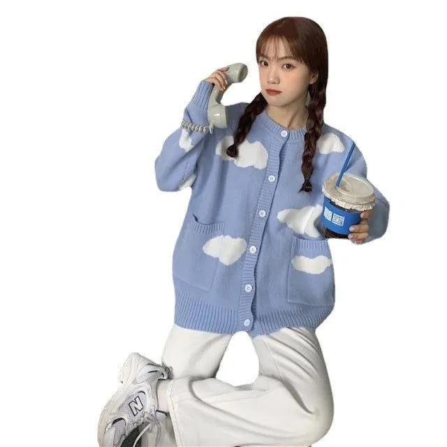 Blue women's loose spandex cardigan with white cloud pattern, worn open.