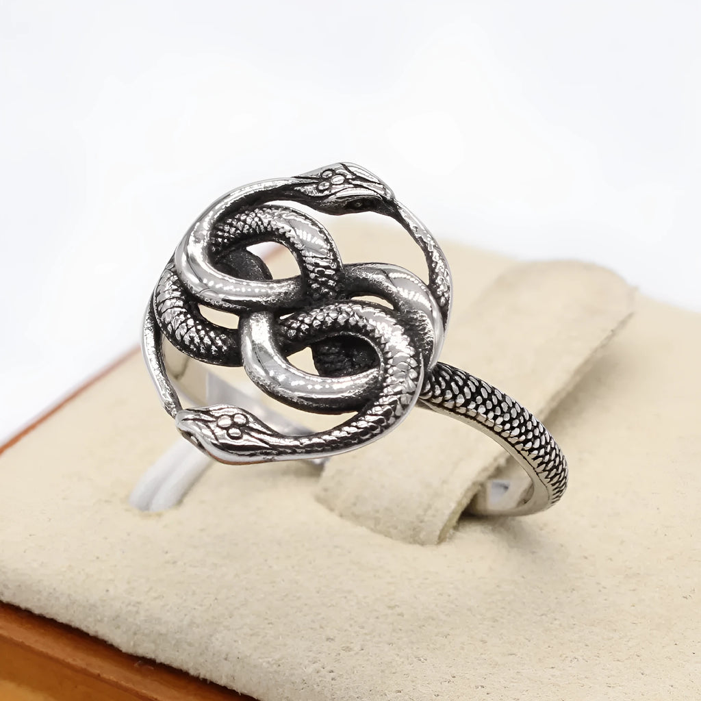 Close-up of a titanium steel double snake ring in a steel colour on a hand.