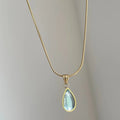 Retro blue and green water drop necklace with mixed gem inlaid pendant on titanium steel snake bone chain.
