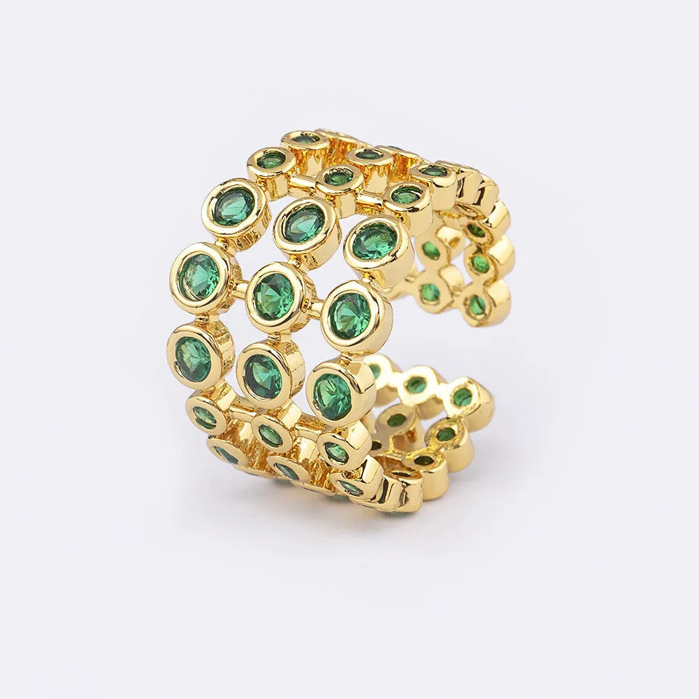 Copper ring with 18K gold plating, green zircon stones, and exaggerated three-layer wide band design.