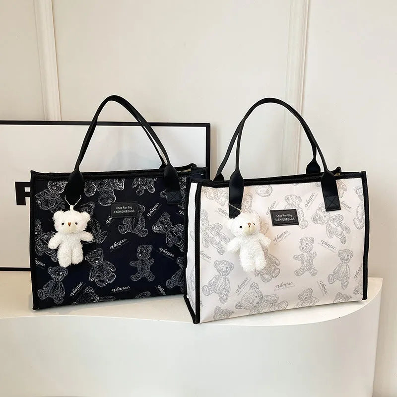 Women's black and white canvas tote bag with diamond pattern and sandwich pocket