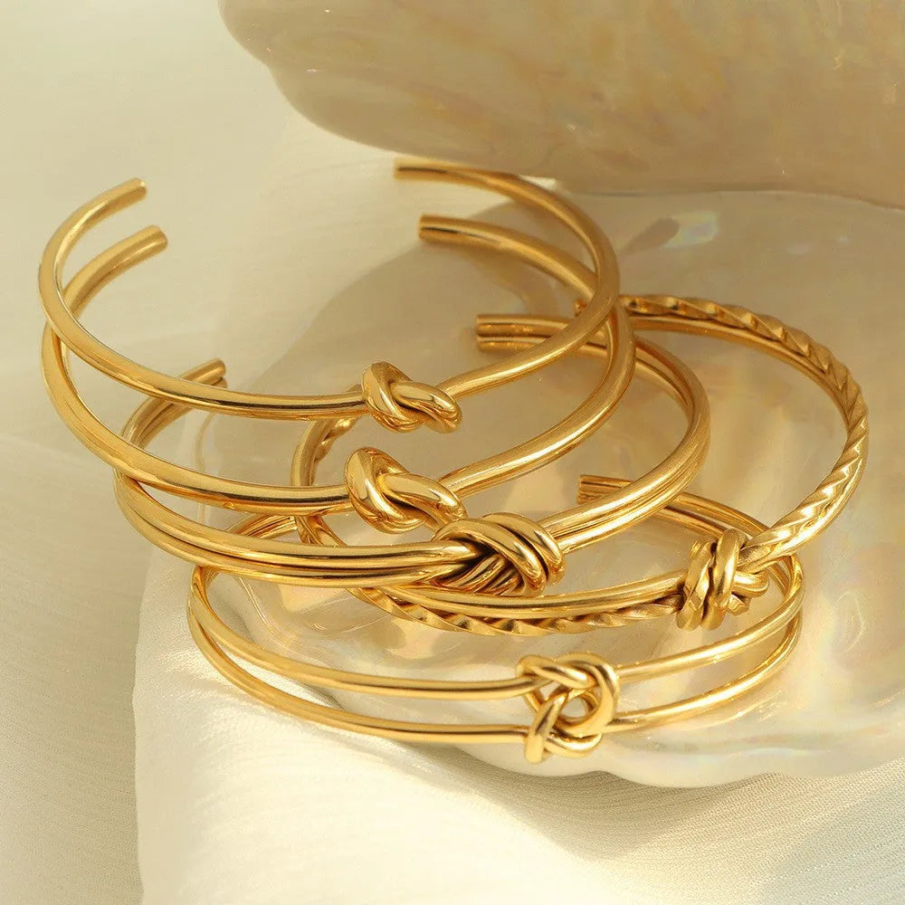 Gold or silver adjustable stainless steel women's bracelet with a C-shaped open design and double-layer knots.