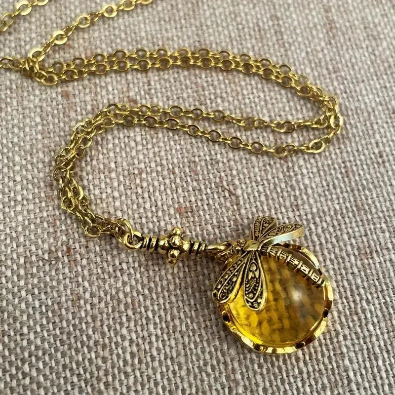 Hand-carved dragonfly pendant necklace in yellow bronze finish on a 925 silver chain.