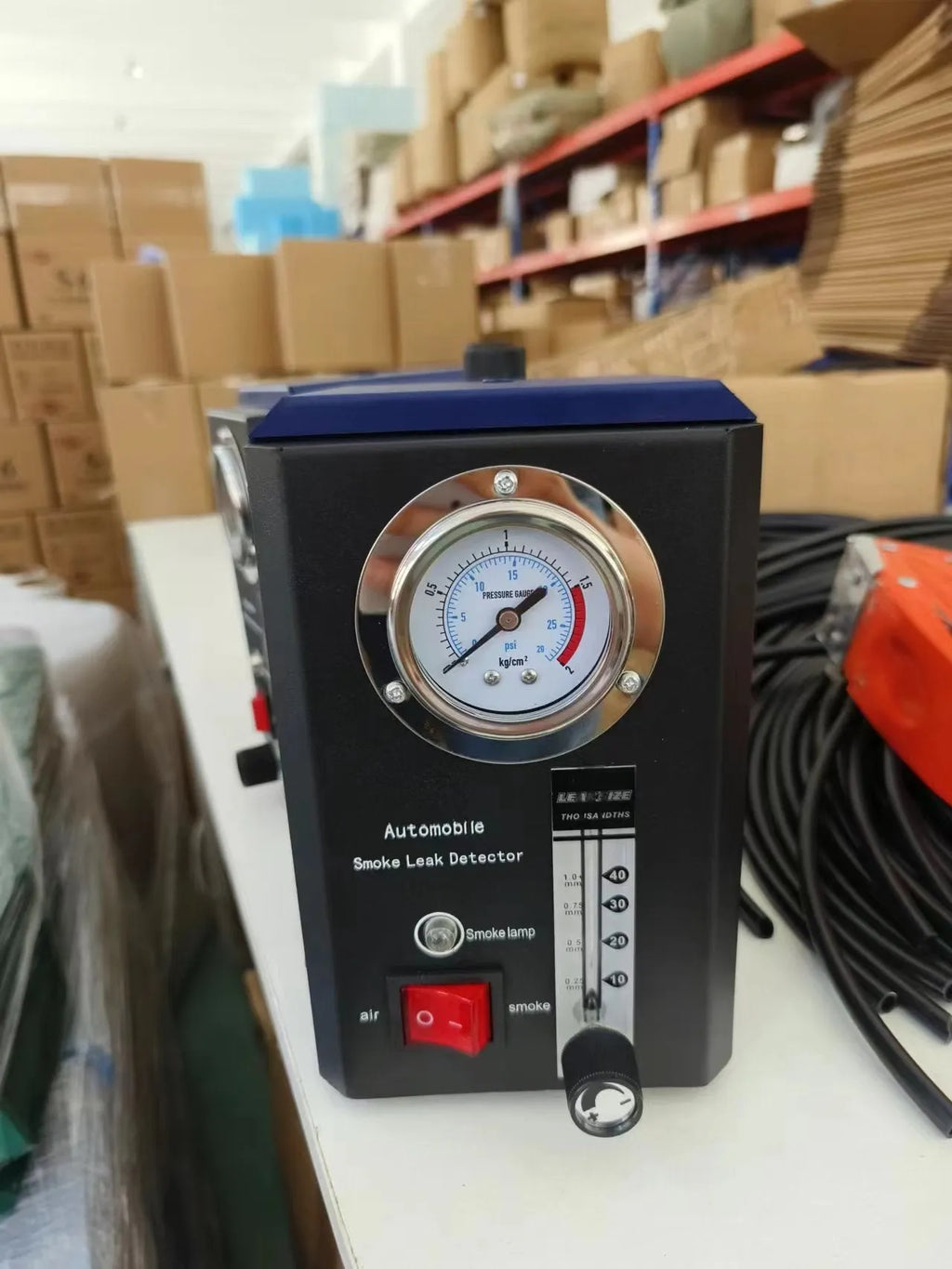KT9105 English specification steel car smoke leak detector on a workshop bench.