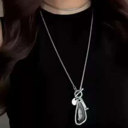 Long women's necklace with geometric pendant on snake bones chain