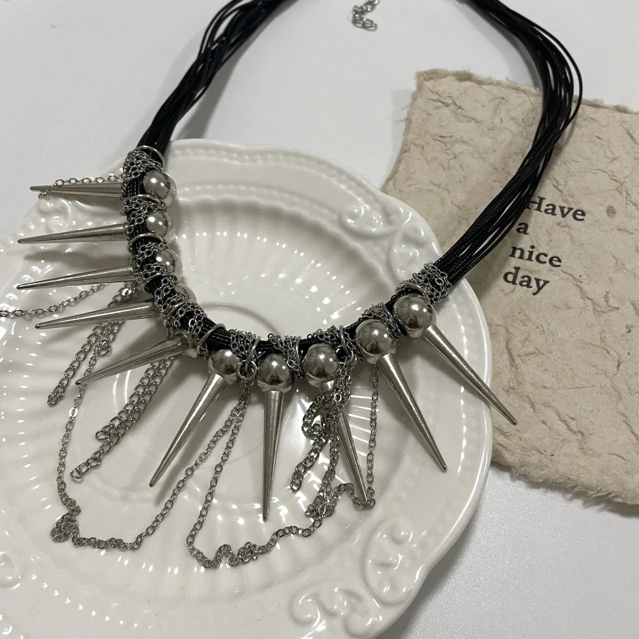 Round beads winding tassel necklace with leather fringe and metal rivet embellishments in picture colour.