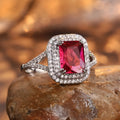 Women's red copper square ring with rhinestone geometric design on a finger.