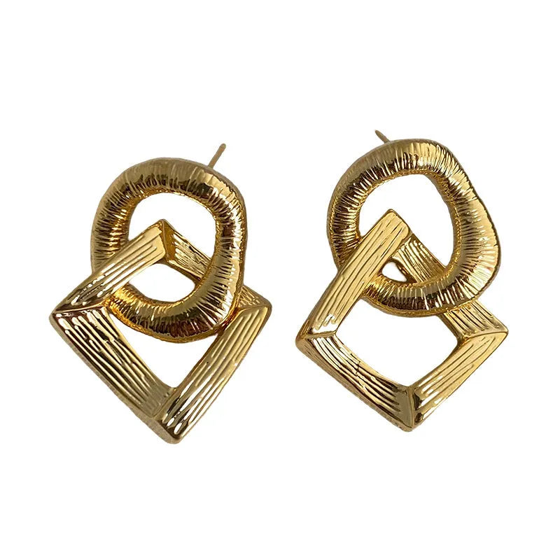 A pair of retro-style geometric circle drop earrings in a gold tone with a 3.4cm pendant length.