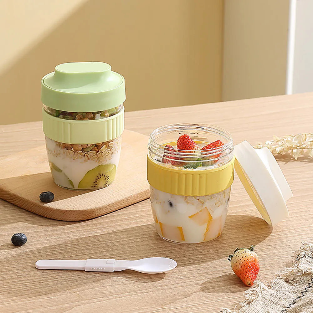 Green plastic salad cup with integrated spoon in lid, shown with leak-proof seal.