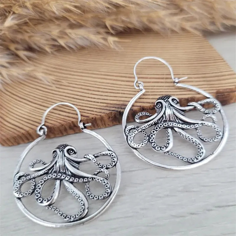 A pair of vintage-style octopus-shaped earrings in an antique silver colour.