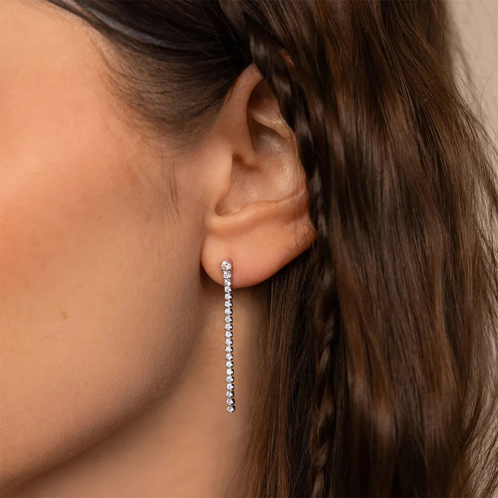 Geometric stainless steel zircon earrings in gold and steel colour on a white background.