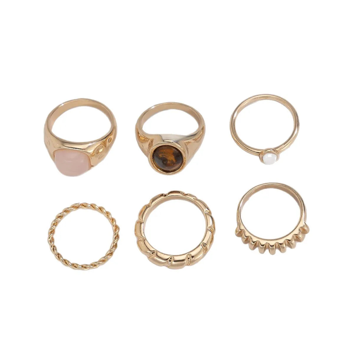 Set of six light gold alloy rings with irregular geometric shapes and rounded elements