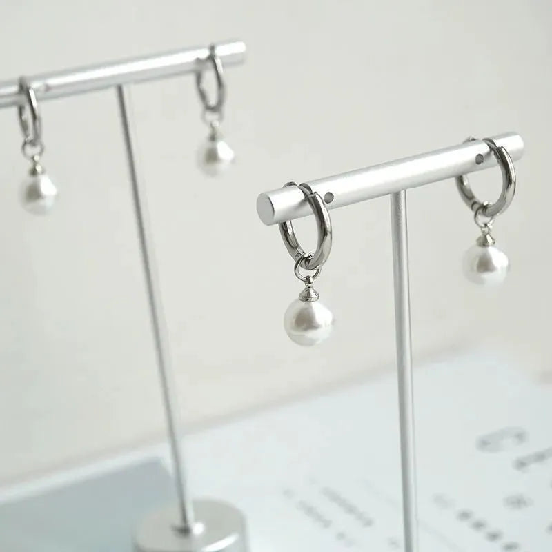 Pair of women's geometric pearl eardrops with titanium steel alloy and round elements in hip hop style