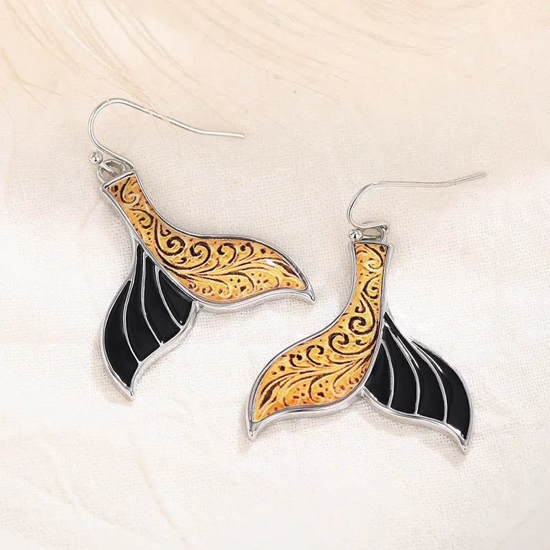 White gold colour alloy fishtail earrings with whale motif retro design