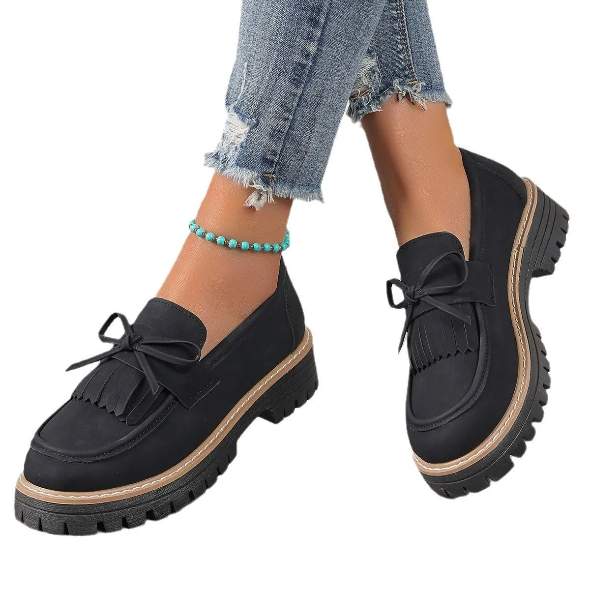 Women's black plus size loafer with tassel and bow decoration on a chunky rubber sole