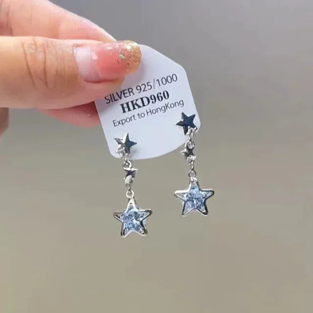 Geometric heart-shaped women's earrings with rhinestones, star charms and a dangling tassel.