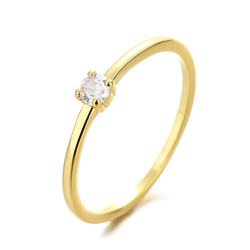 A simple single diamond ring with a fine circular copper band, shown in blue, green, red, and white colour variations.
