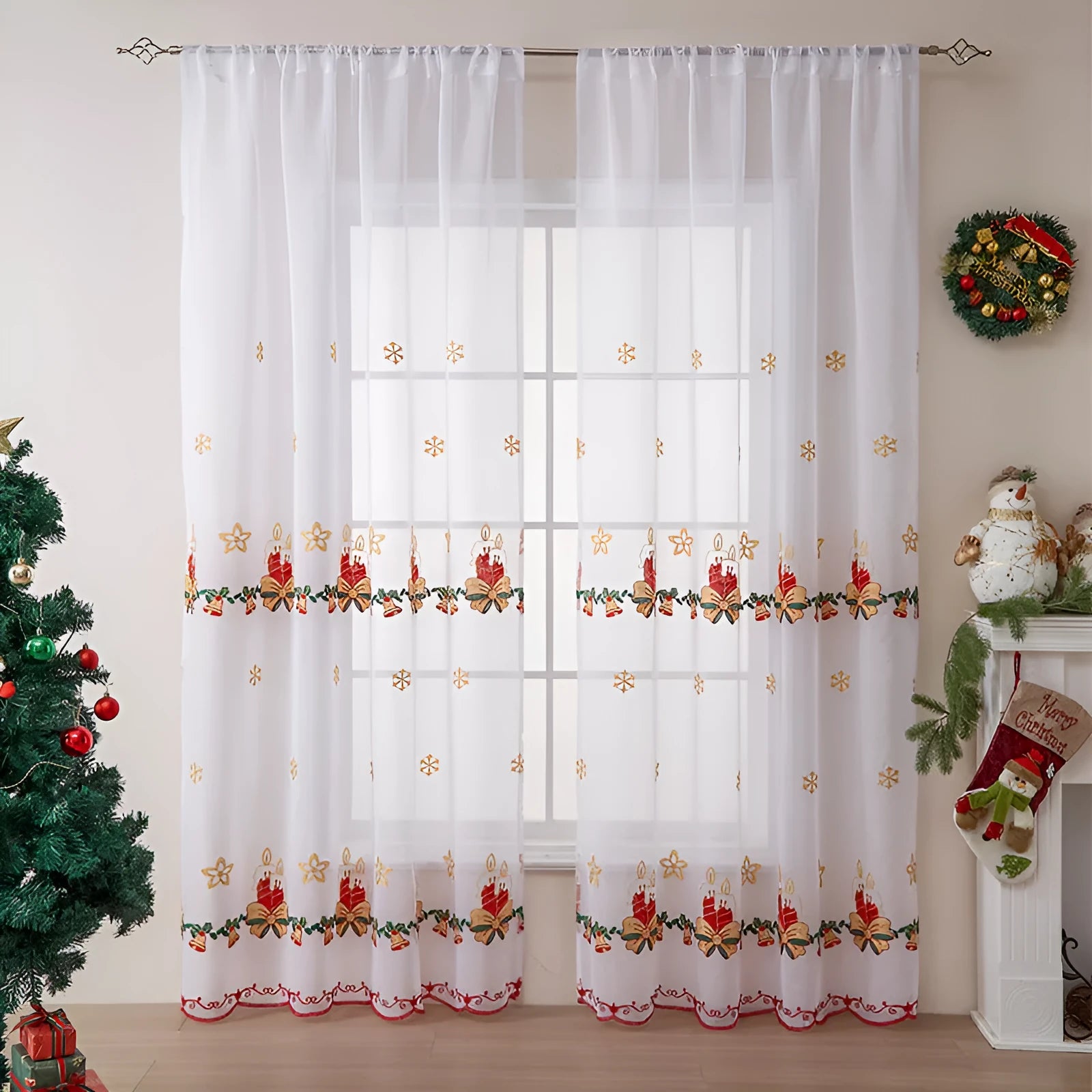Pair of white Christmas curtains with red and green embroidered snowflakes, shown hanging in a window.