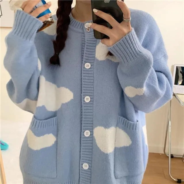 Blue women's loose spandex cardigan with white cloud pattern, worn open.