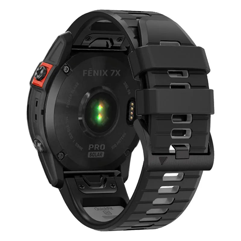 Two-tone quick release silicone strap for Garmin Fenix watch next to a watch case.