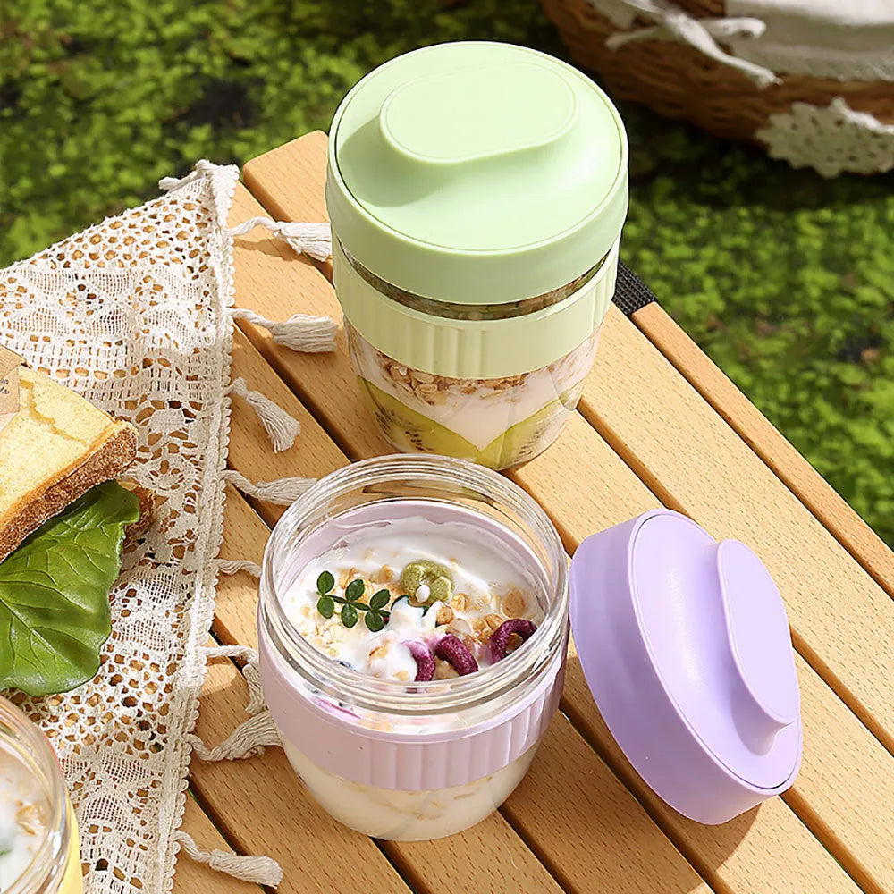 Green plastic salad cup with integrated spoon in lid, shown with leak-proof seal.