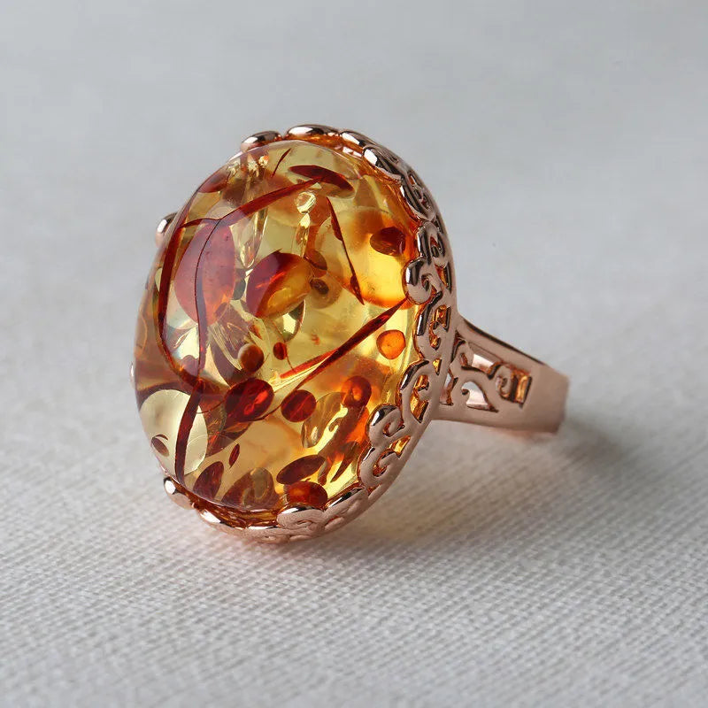 Close-up of an amber and beeswax ethnic style ring with an alloy base in a retro elegant design.