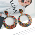 Large round metal pendant earrings with diamond accents in cartoon style for women