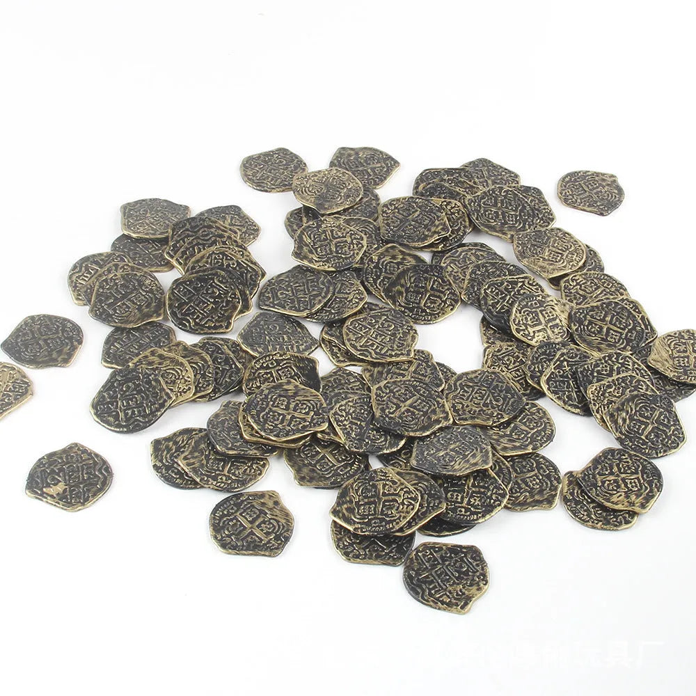 A pile of gold, silver, and bronze plastic Roman coin replicas from a 100-piece set.