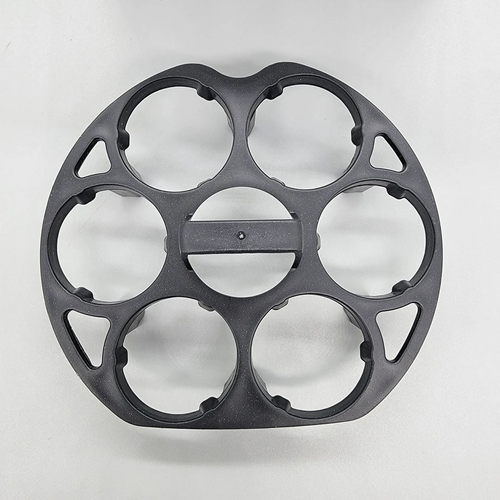 A black plastic egg holder rack on a kitchen countertop.