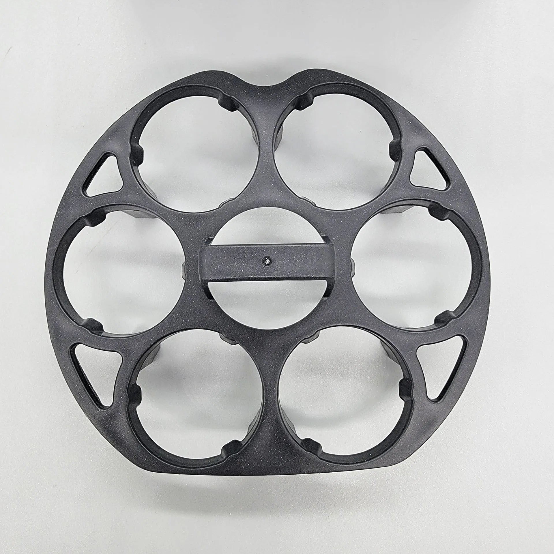 A black plastic egg holder rack on a kitchen countertop.