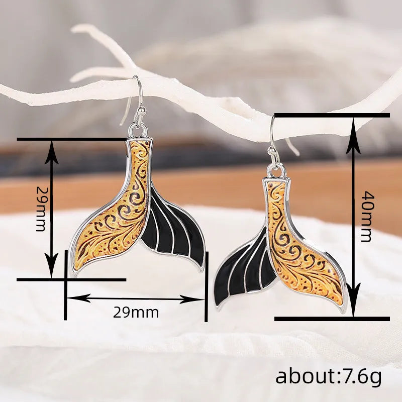 White gold colour alloy fishtail earrings with whale motif retro design