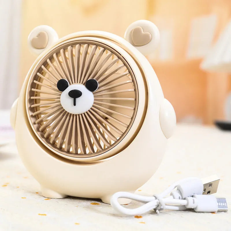 Cute dog-themed USB desktop electric fan in a choice of six colours on a wooden desk.