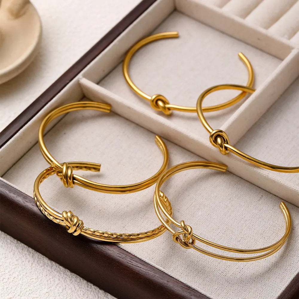 Gold or silver adjustable stainless steel women's bracelet with a C-shaped open design and double-layer knots.