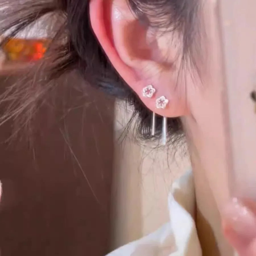 Silver hollow flower hanging earrings with petal design and sterling silver needle