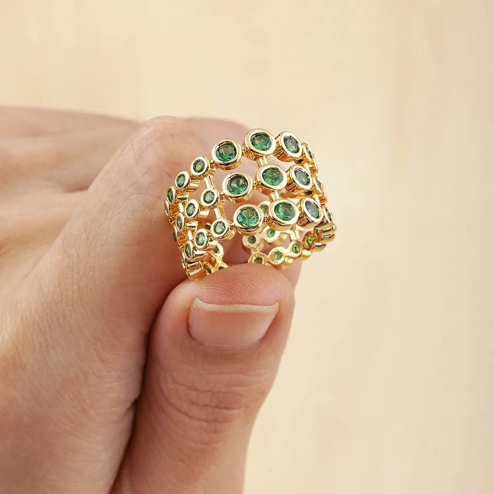 Copper ring with 18K gold plating, green zircon stones, and exaggerated three-layer wide band design.