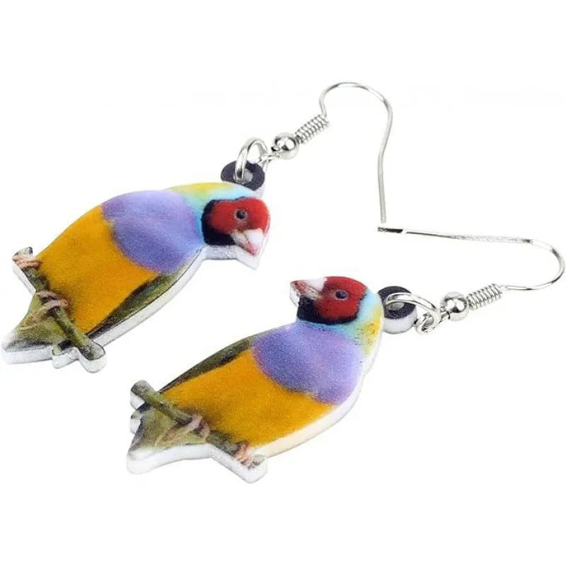 A pair of blue titmouse bird pendant earrings made from clear acrylic with geometric shapes and snake chain links.