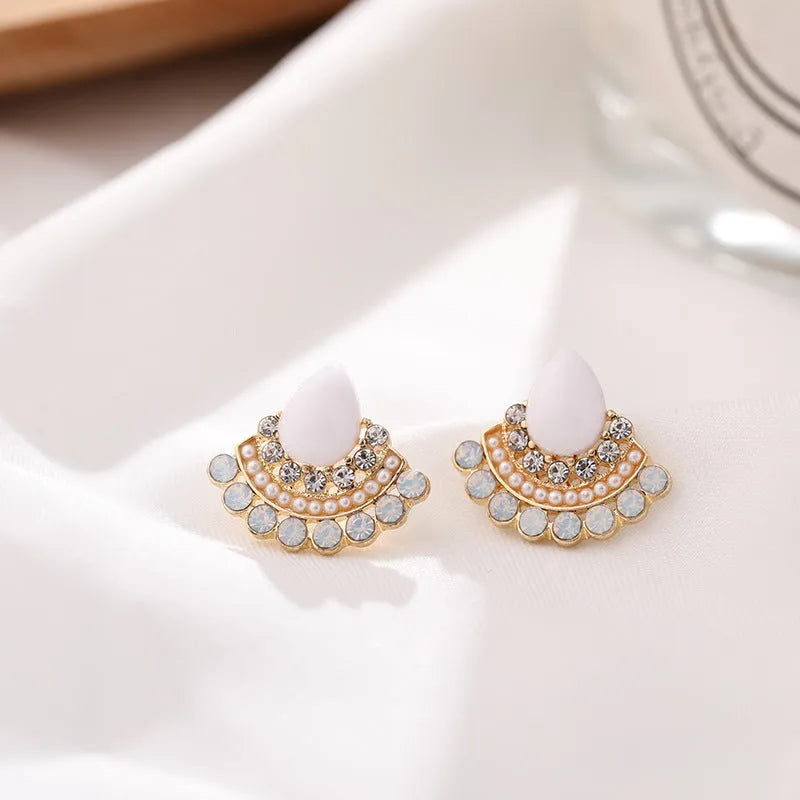 Women's retro fan-shaped silver needle earrings with rhinestone detailing on a geometric design.