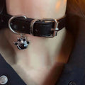 Black leather dog collar with bell pendant showing adjustable design from 21cm to 50cm perimeter
