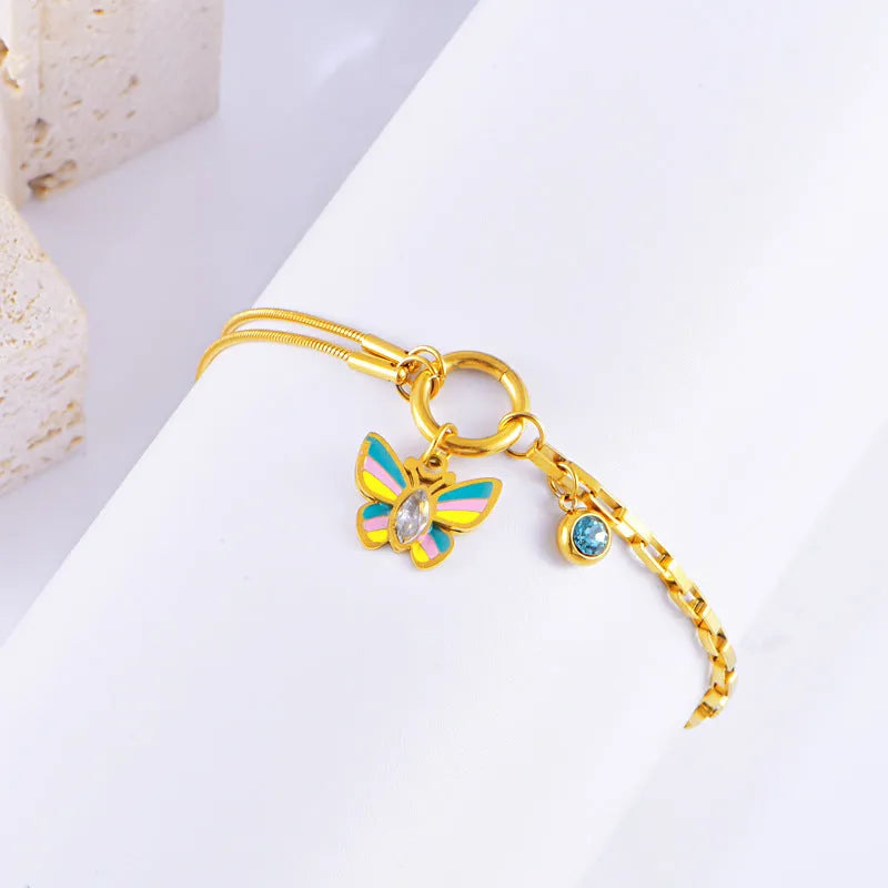 Gold colour epoxy butterfly jewellery set with titanium steel necklace and bracelet showing snake bones chain style