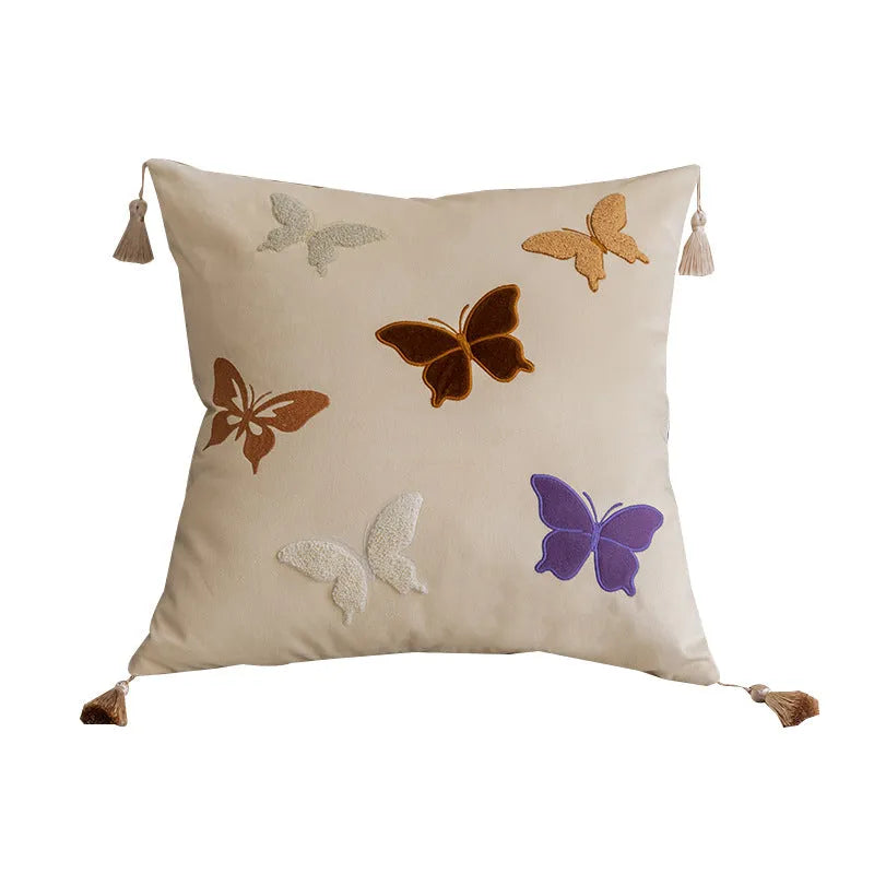 Square beige cushion with detailed purple and black butterfly embroidery in a Chinese floral pattern.