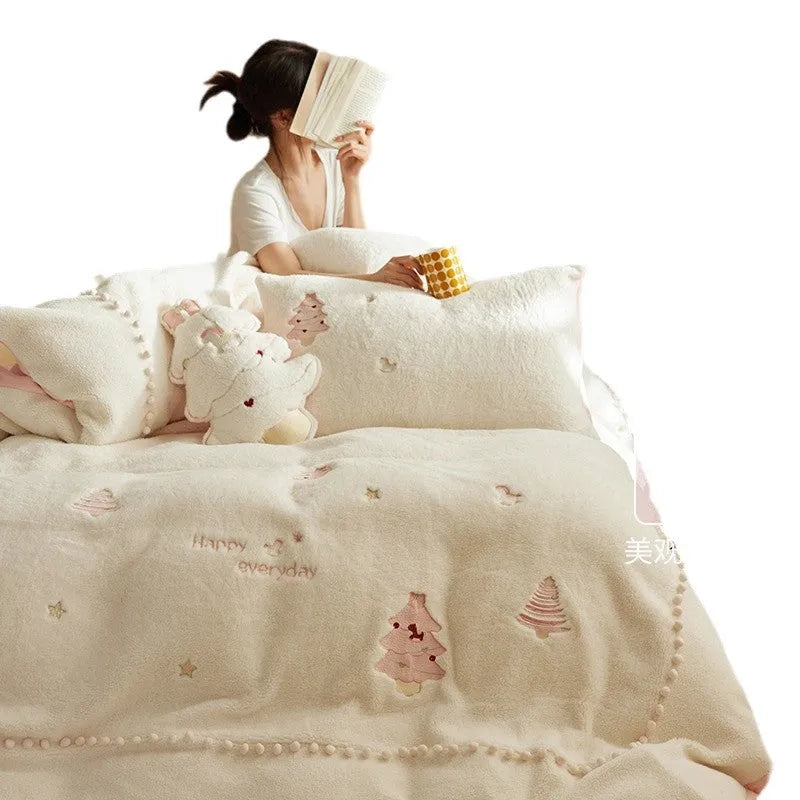 Winter milk fibre bedding four-piece set with green Christmas tree pattern on a bed.