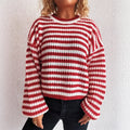 Women's loose vintage stripe knitted pullover sweater in red, shown on a hanger.
